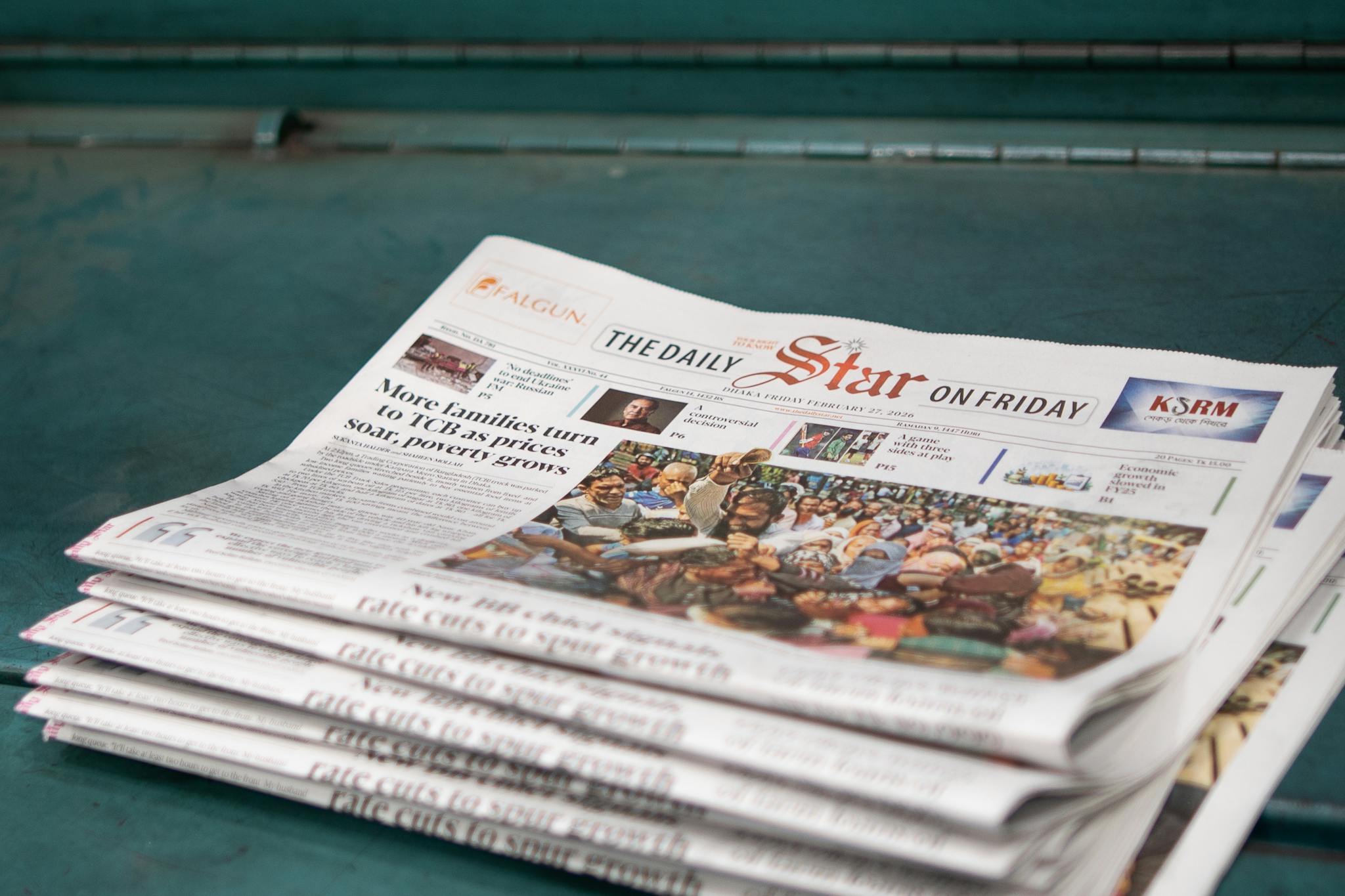 Stack of 'The Daily Star' newspapers showcasing a headline on rising poverty and price issues.