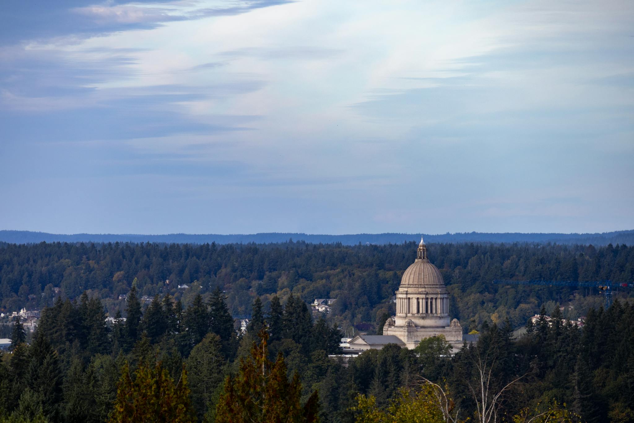 View of Washington State Capitol amidst lush forests in Olympia, Washington.